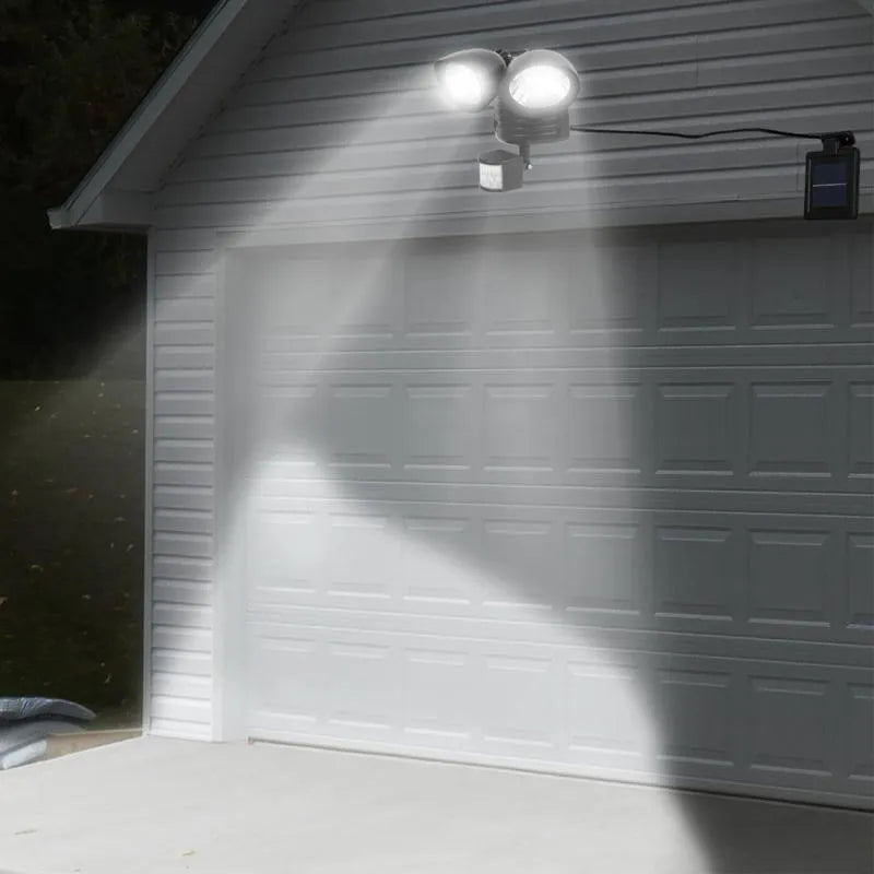 Black and white dual-head solar security spotlight with motion sensor for outdoor wall mounting