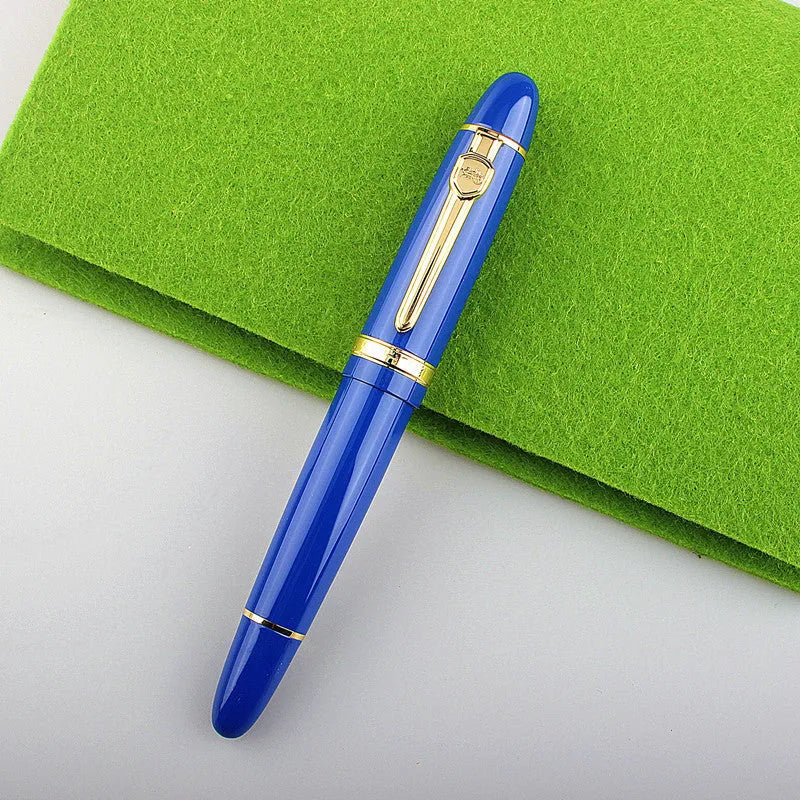 Metal ball pen with pearl beads, black body and silver clip, lying on a desk