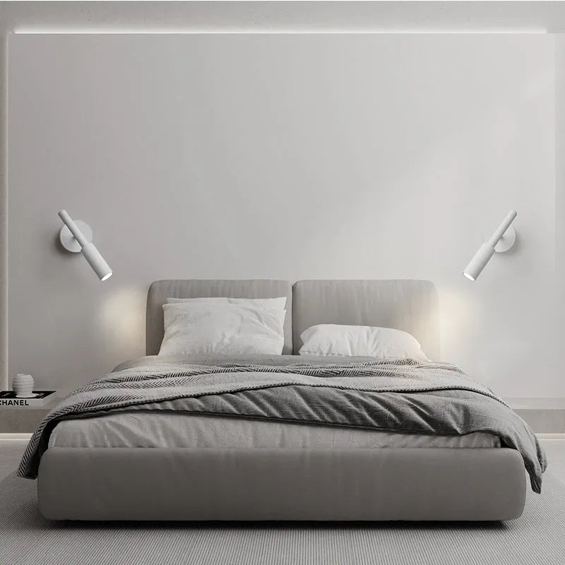 Black and white modern wrought iron wall lamp with a compact shade.