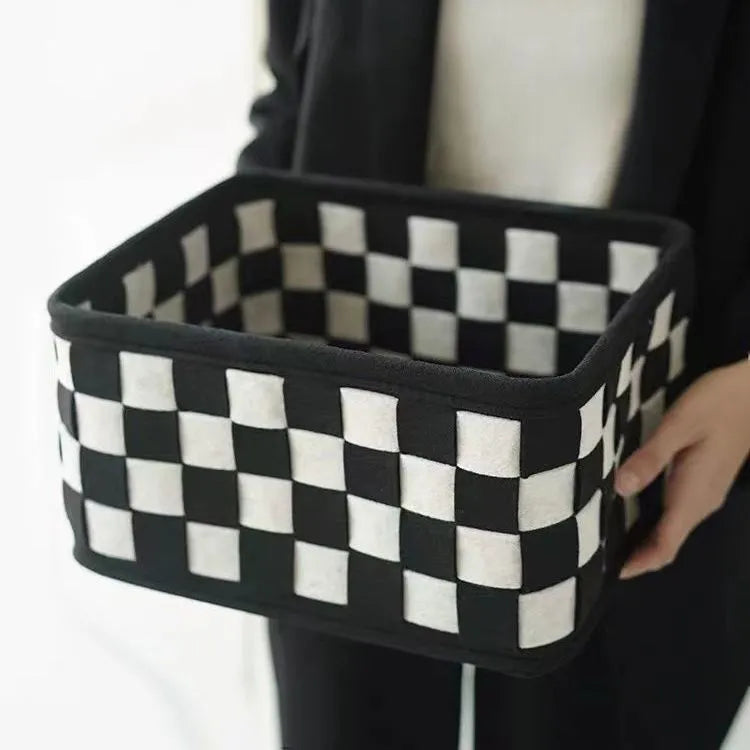 Checkerboard patterned felt folding storage basket showing its size and textured weave.