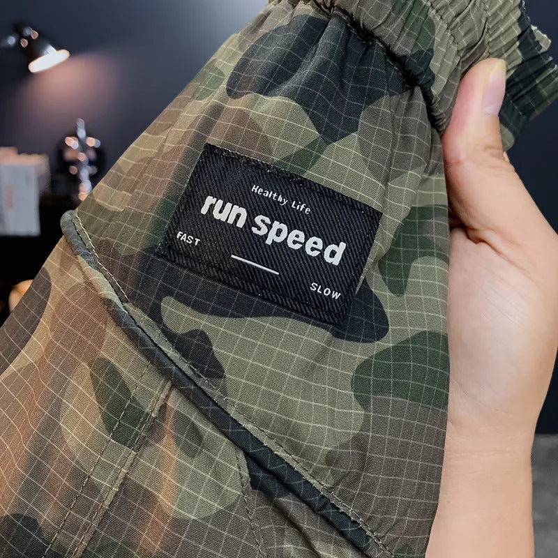Men's camouflage cargo shorts in a loose fit with cargo pockets, shown in khaki colour.