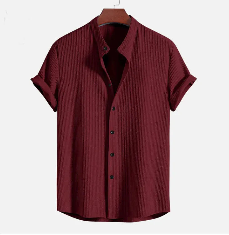 Mans loose-fitting short sleeve casual shirt in solid colour on hanger.
