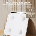White professional body fat scale with 8 electrodes and a tempered glass platform.