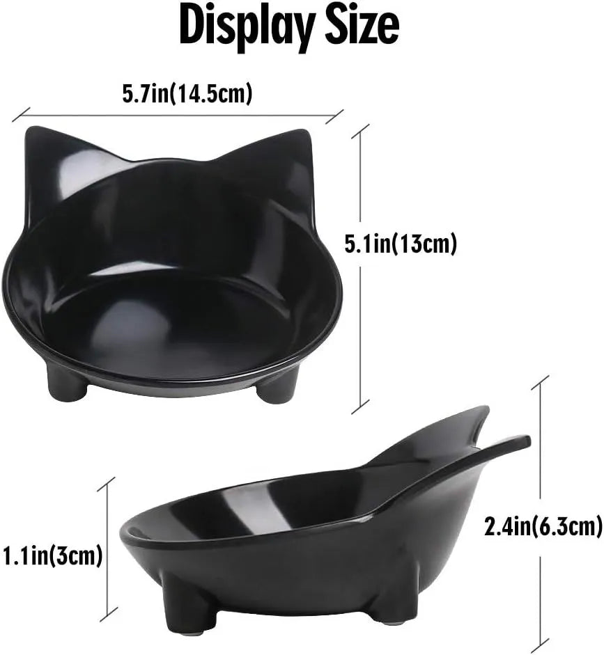 Shallow black and white melamine pet bowls with non-slip rubber bases on a kitchen floor.