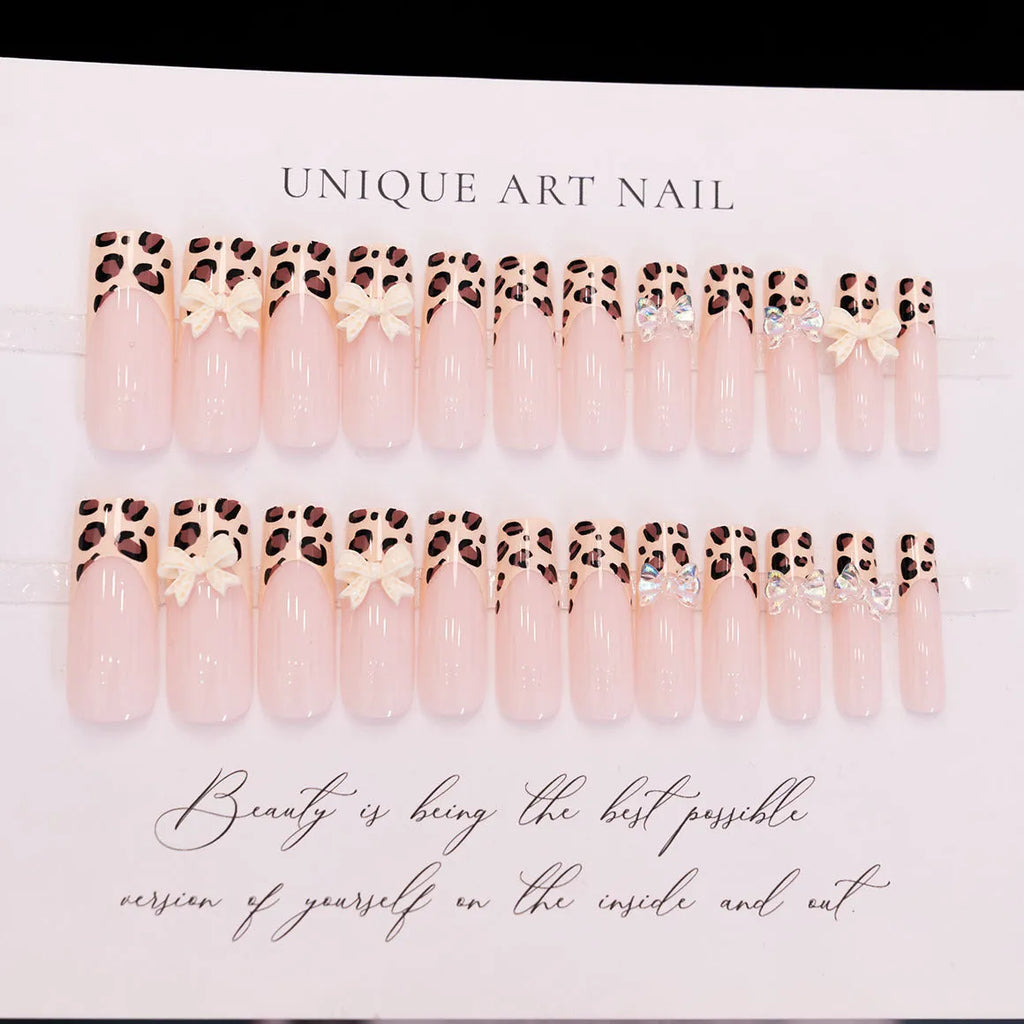Set of plastic leopard print butterfly nail art decoration pieces on a background.