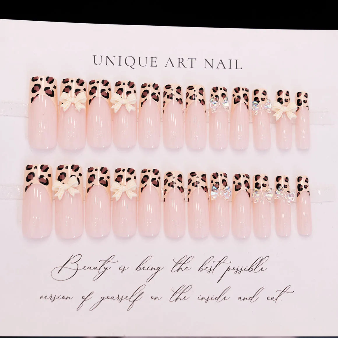 Set of plastic leopard print butterfly nail art decoration pieces on a background.