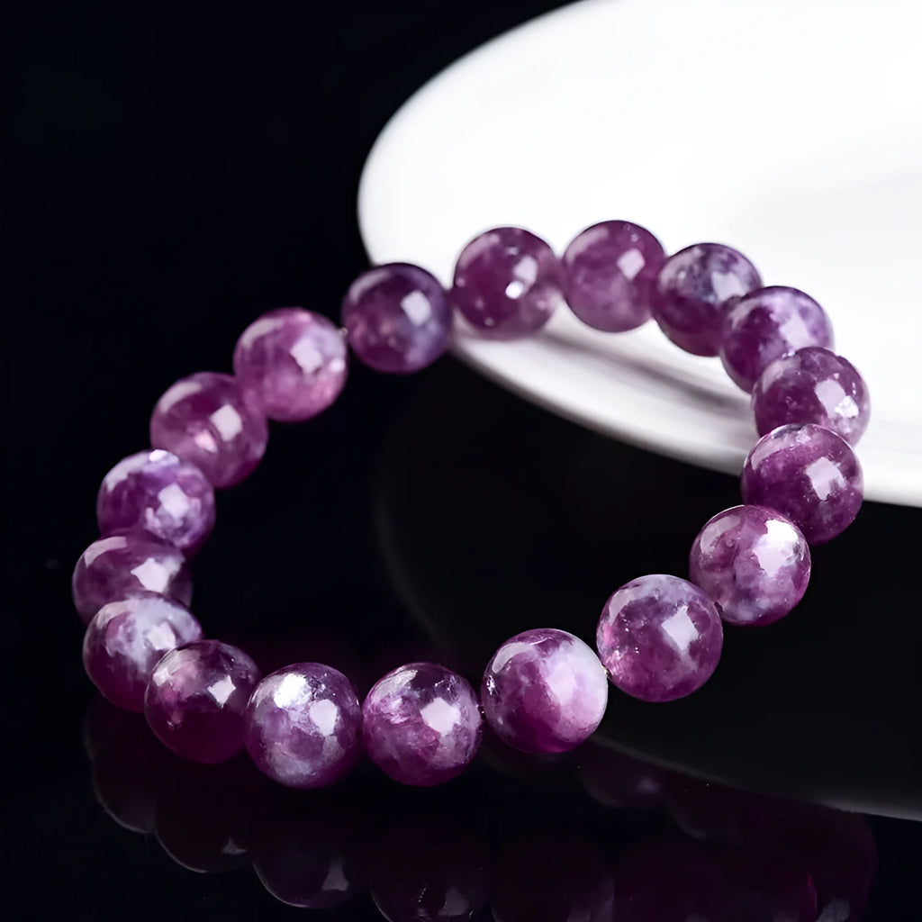 Grandmother crystal bracelet with polished purple geometry beads on a white background.