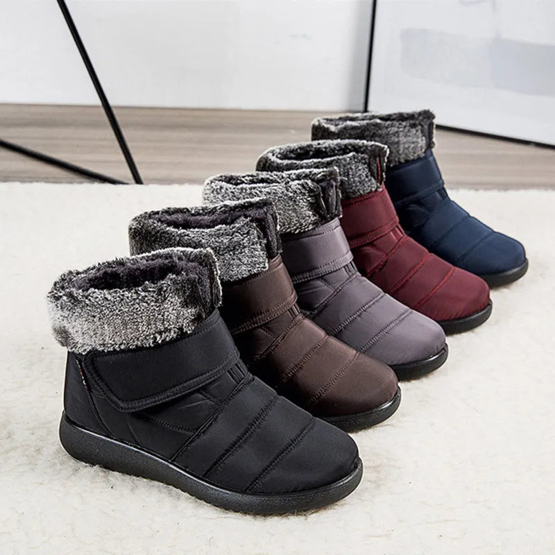 Women's winter snow boots with plush lining, suede upper, velcro strap, flat heel, and anti-skid rubber sole in black.