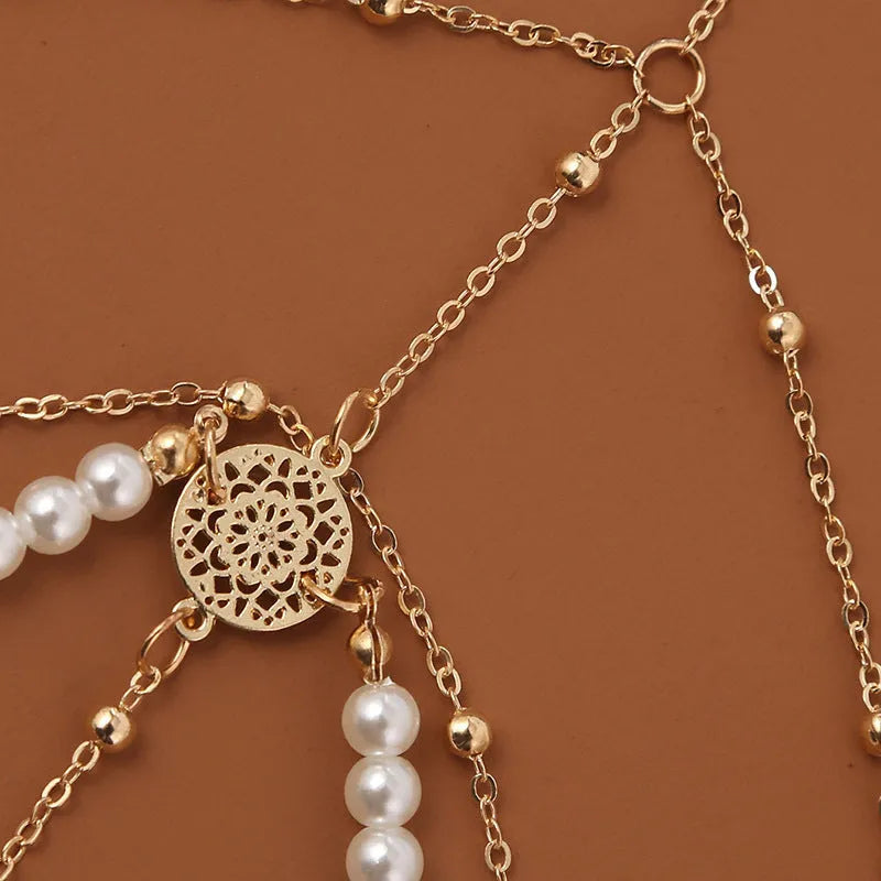 Women's white pearl multi-layer geometric body chain anklet on a light background