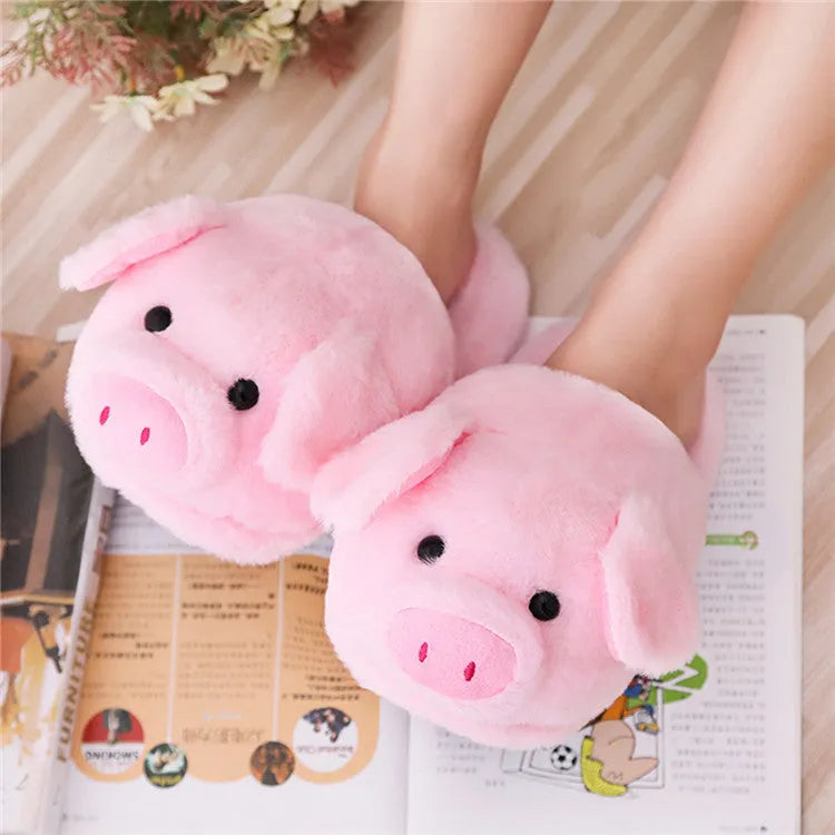 Pink adult pig-shaped floor slippers with short plush fabric on a white background.