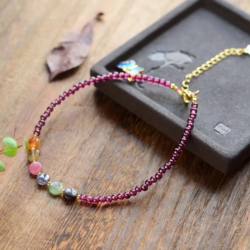 Purple garnet geometric anklet for women on an ankle.
