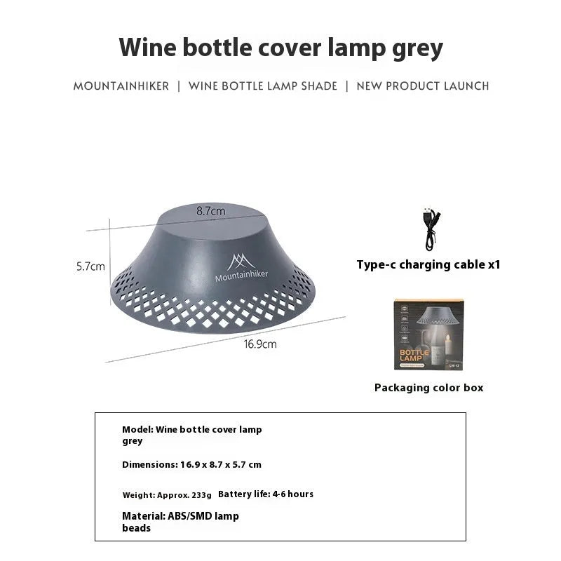Beige rechargeable wine bottle shaped camping lantern with USB-C port and switch, shown illuminated.