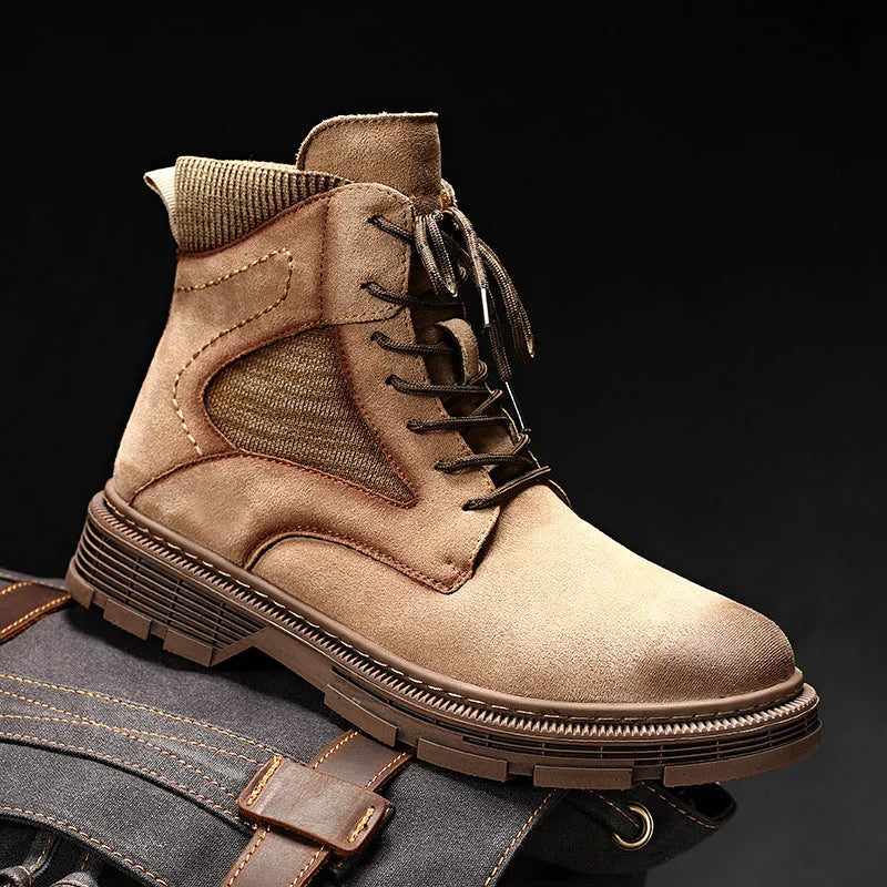 Men's frosted brown Martin boots with round toe and thick rubber sole on a wooden surface.