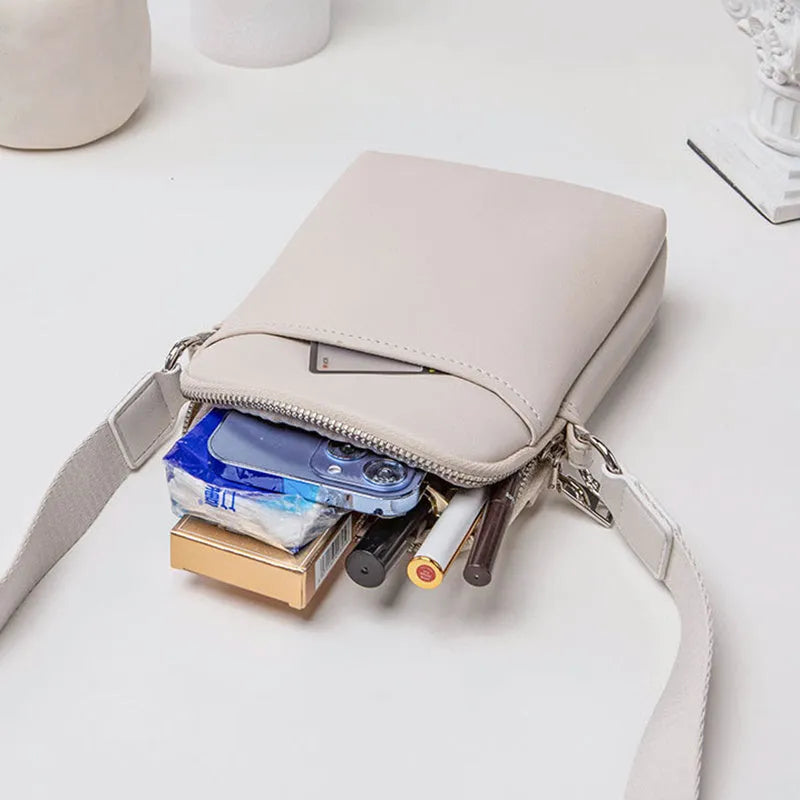 Solid colour PU leather crossbody shoulder bag for women with adjustable strap.