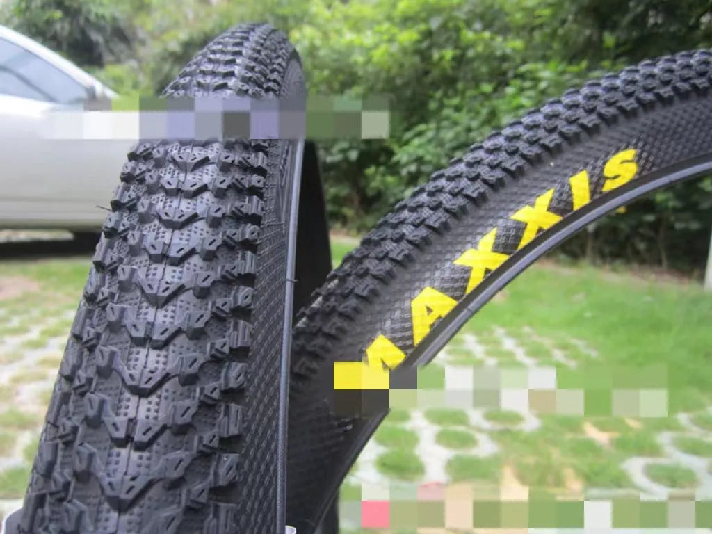 Mountain bike tyre with tread, shown in multiple size options: 26, 27.5 and 29 inch diameters.