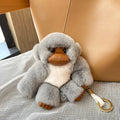 Lucky Little Monkey long arm Rex rabbit fur bag pendant in brown, attached to a bag strap