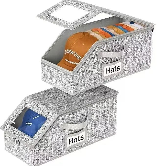 Grey foldable and stackable woven fabric storage box for organising baseball caps and shoes.