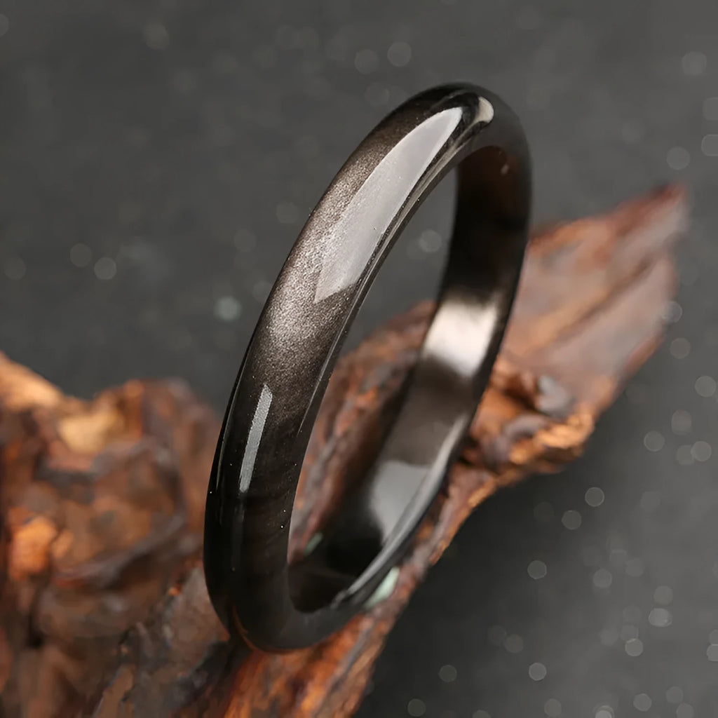 Natural silver stone cat's eye bracelet in national style with geometric design on a wrist.