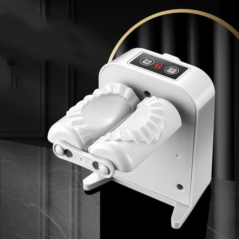 White automatic electric dumpling maker machine with USB cable, brush, and spoon on a kitchen counter.
