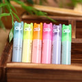 Set of six oblique highlighter pens with plastic shells in assorted colours, presented in a bag.