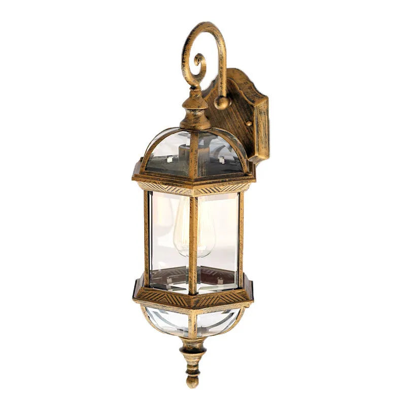 Gold aluminium outdoor wall lamp with three-layer design mounted on a brick wall.