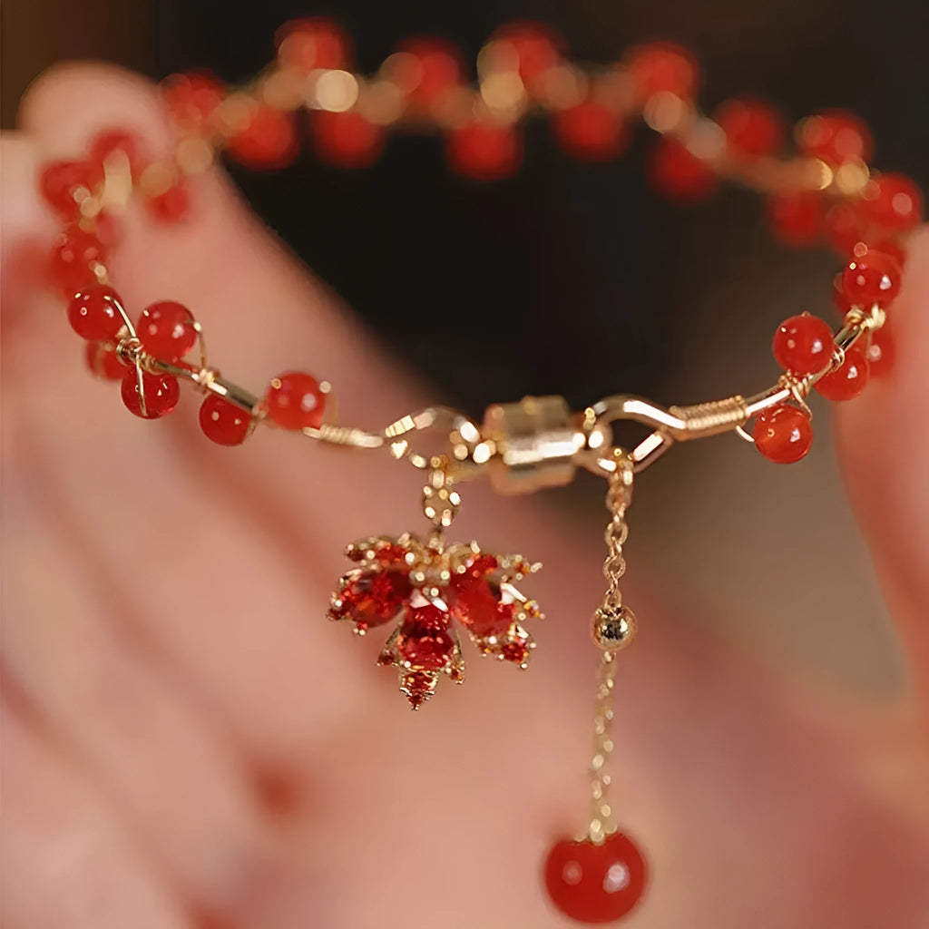 Red ginkgo leaf charm on an alloy magnetic bracelet in a Chinese style.
