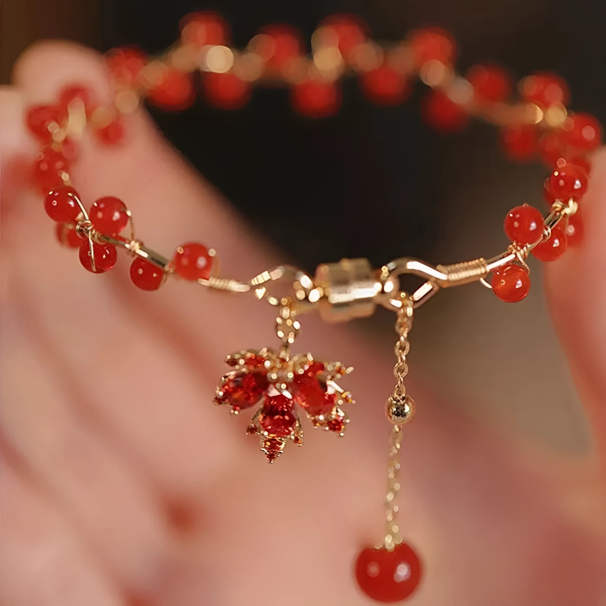 Red ginkgo leaf charm on an alloy magnetic bracelet in a Chinese style.