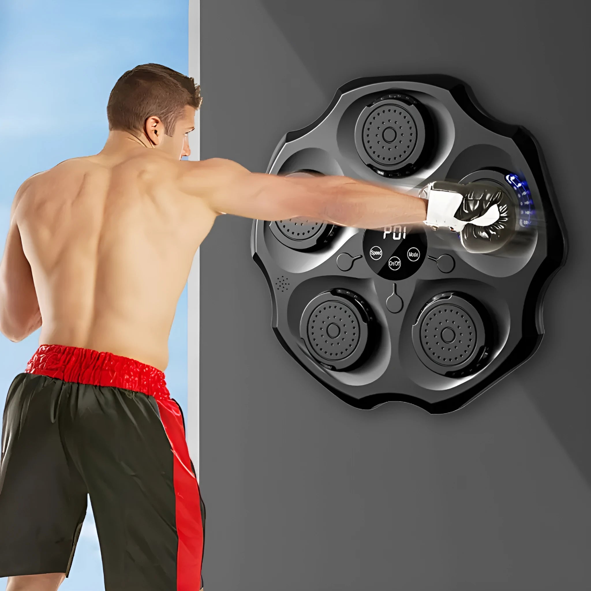 Black Bluetooth music-responsive boxing wall target hanging on a wall with included punching gloves.