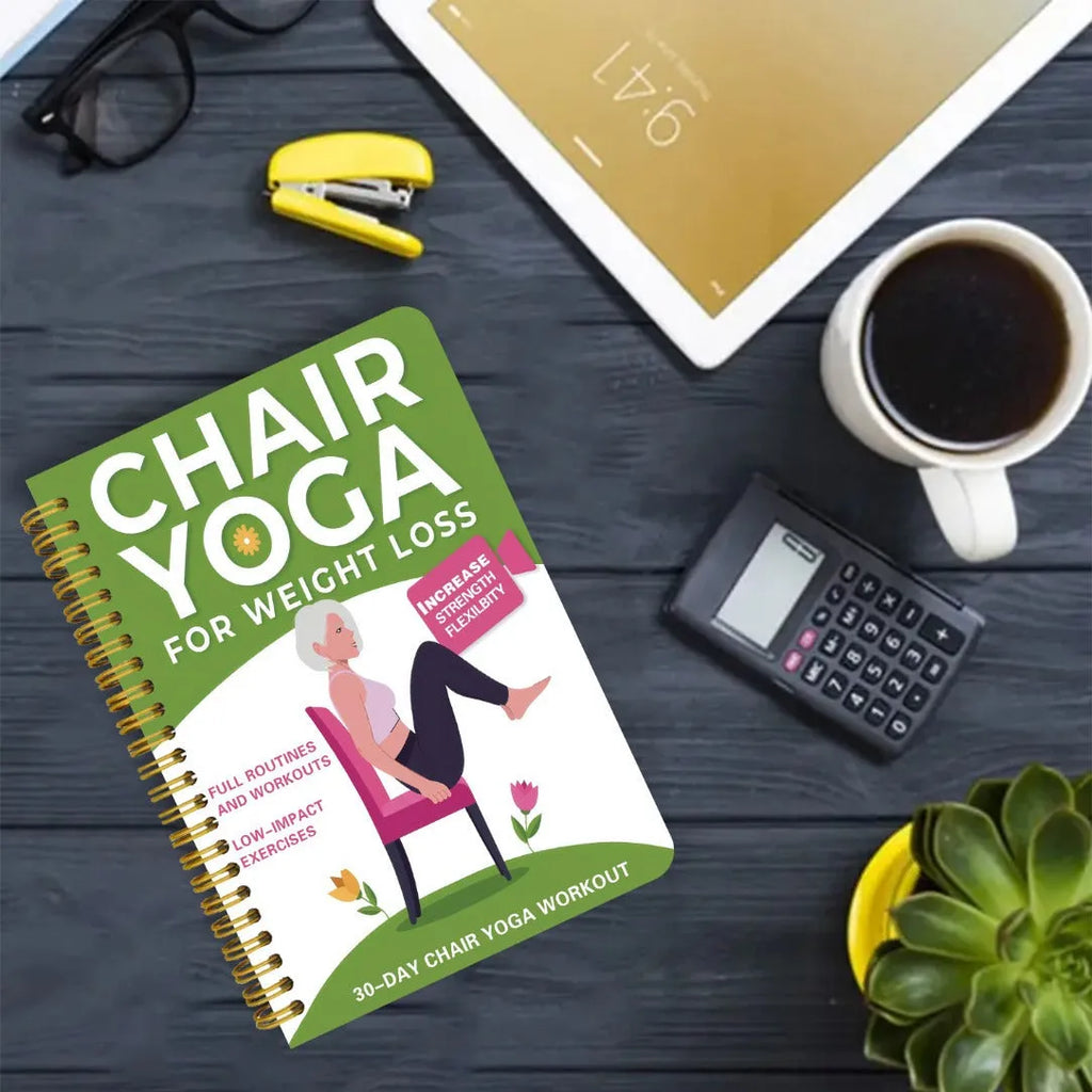 Green coil-bound 30-day chair yoga training notebook with open pages showing exercise plans