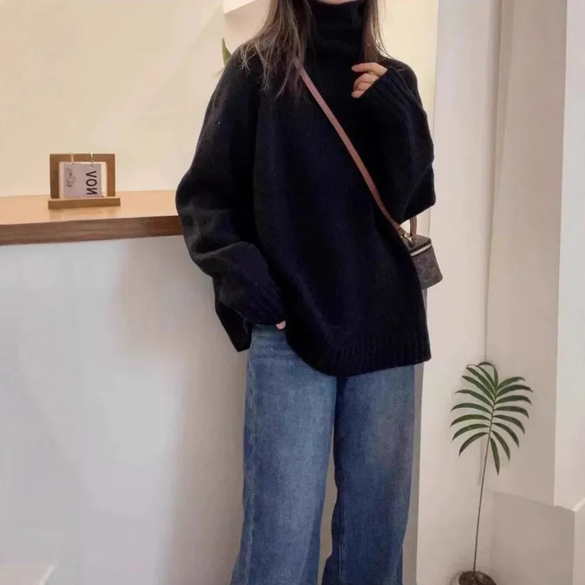 Women's loose fit black turtleneck sweater with a thick curling pile collar.