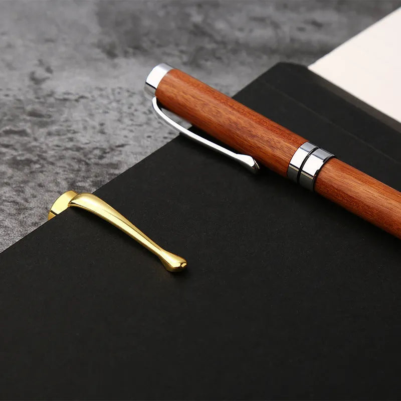 Rosewood and metal ballpoint pen 14cm long with gold and silver finish options on a white background