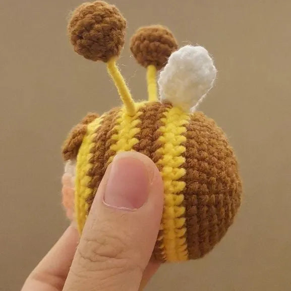 Handmade crocheted bee colony wool doll with bee pendant accessory in plush soft toy construction