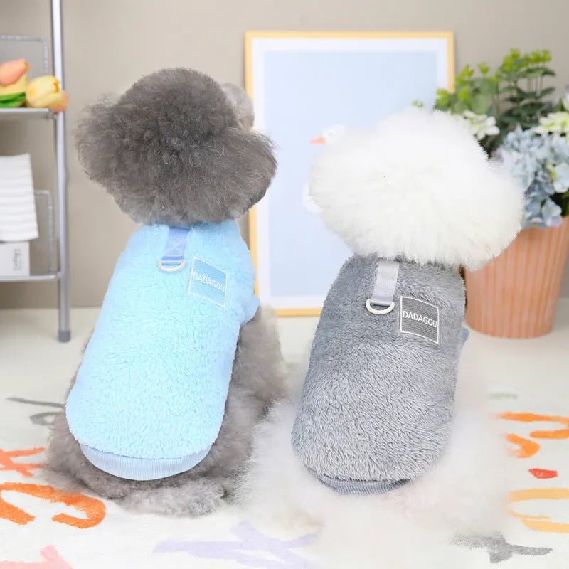 A soft coral fleece dog jacket shown in blue, available in sizes S to XXL.