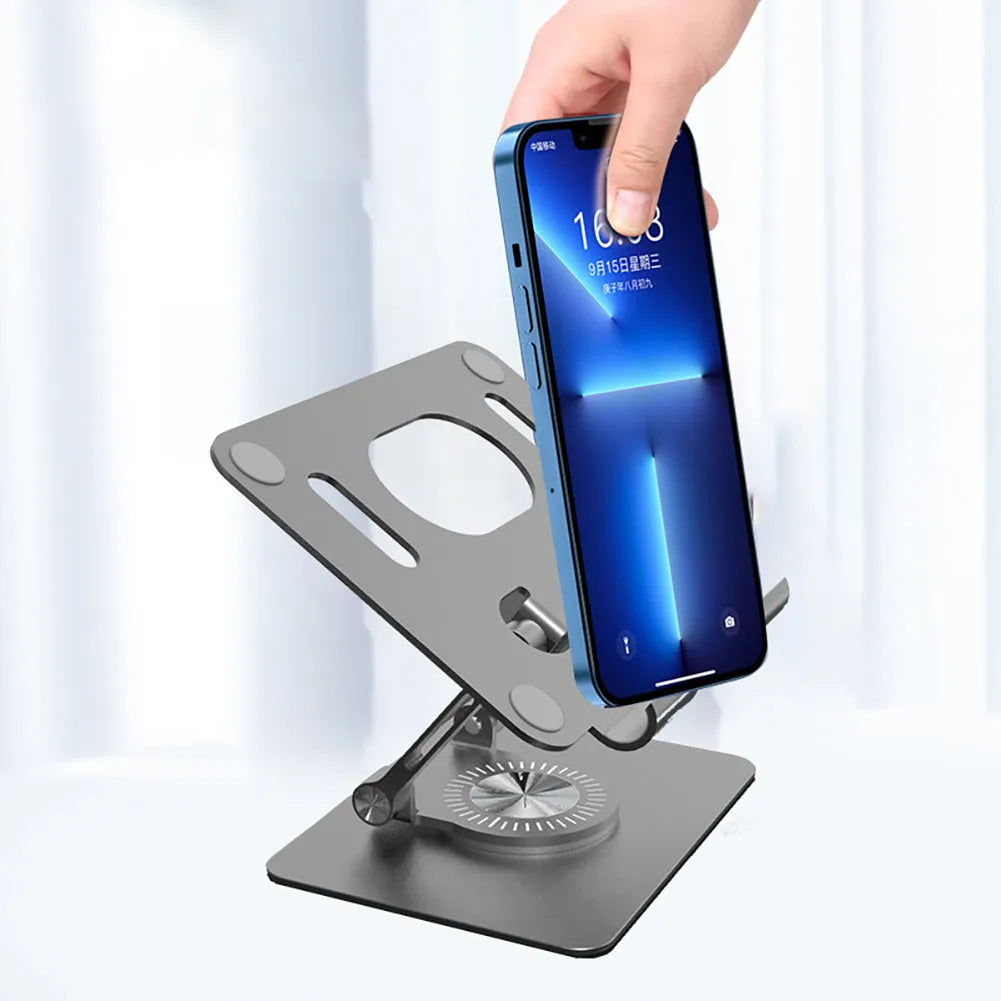 Rotating metal tablet stand with aluminium plate shown in silver colour at an adjusted height.
