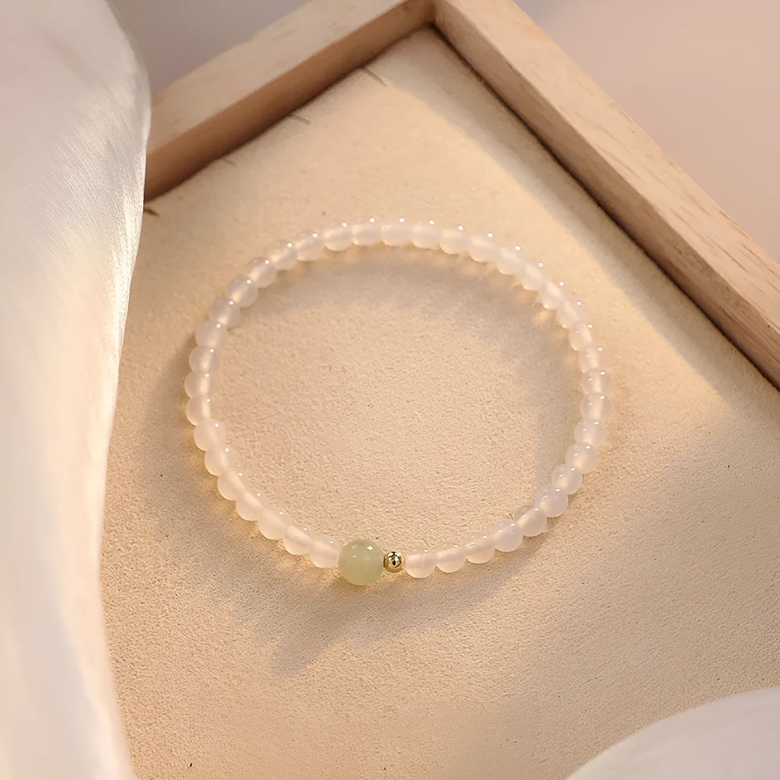 Natural white agate women's bracelet on wrist showing handmade beads and 15cm length.