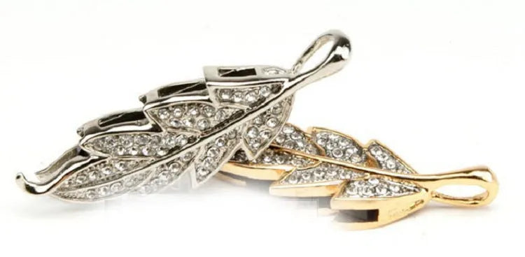 Silver metal USB flash drive shaped like a crystal maple leaf on a white background.
