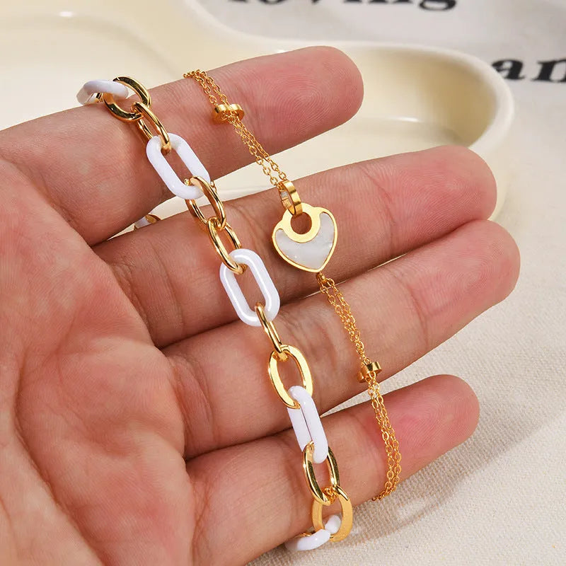 Silver stainless steel bracelet for women with a double-layer red resin heart charm.