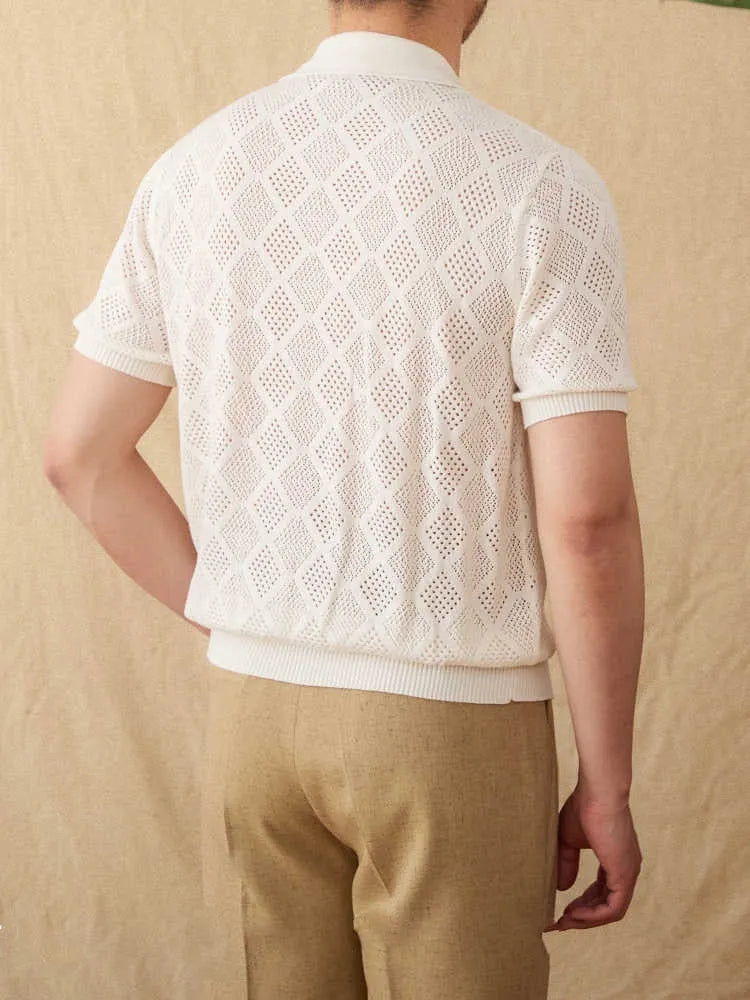 Man wearing a light brown zip-front cotton cardigan with short sleeves and a lapel collar.