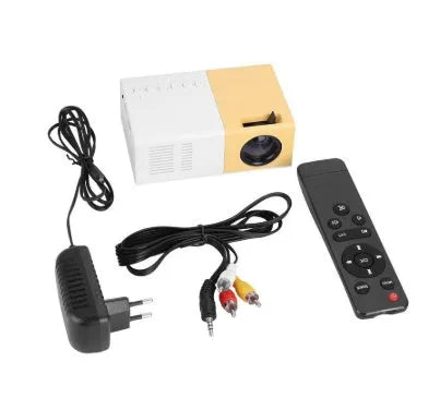 Mini LED projector YG300 in white and yellow, with lens and ventilation grilles, on a table