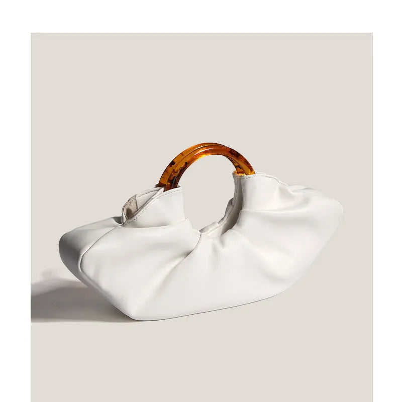 Niche Horn Bag acrylic ring handbag in black PU leather with fold design detail