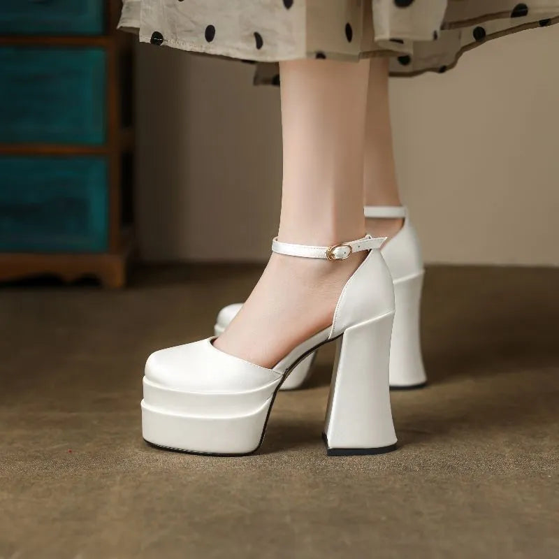 Women's white platform high heels with a chunky heel and round toe on a plain background.