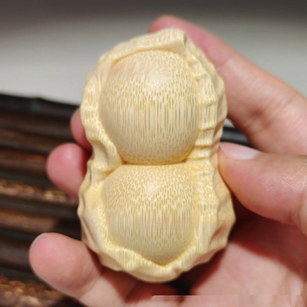 Solid bamboo carving peanut ornament on natural background