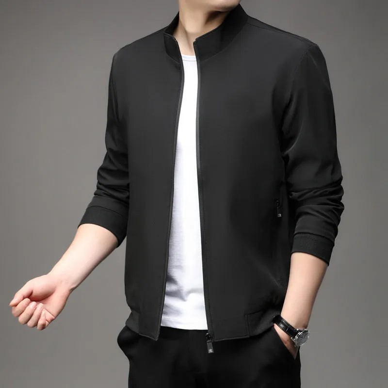Man wearing a loose-fit grey lapel jacket, a Korean-style autumn casual outerwear piece with zipper pockets.
