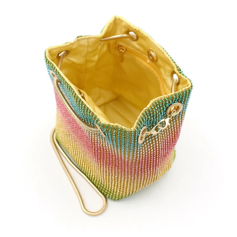 Soft rainbow-coloured rhinestone bucket bag with a flexible structure and classic shape.
