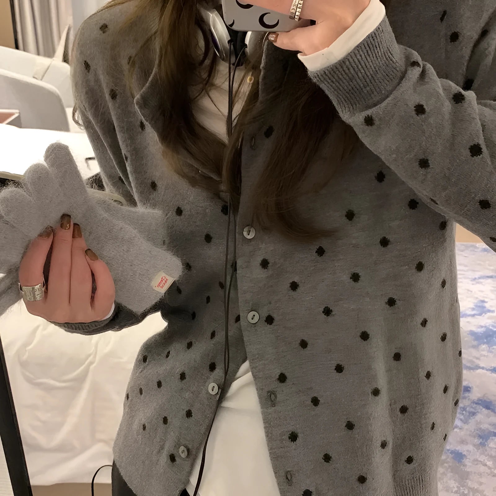 Women's grey dot pattern knitted cardigan with crocheted flower details on front
