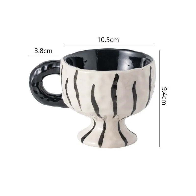 Handmade irregular solid colour ceramic mug on a table