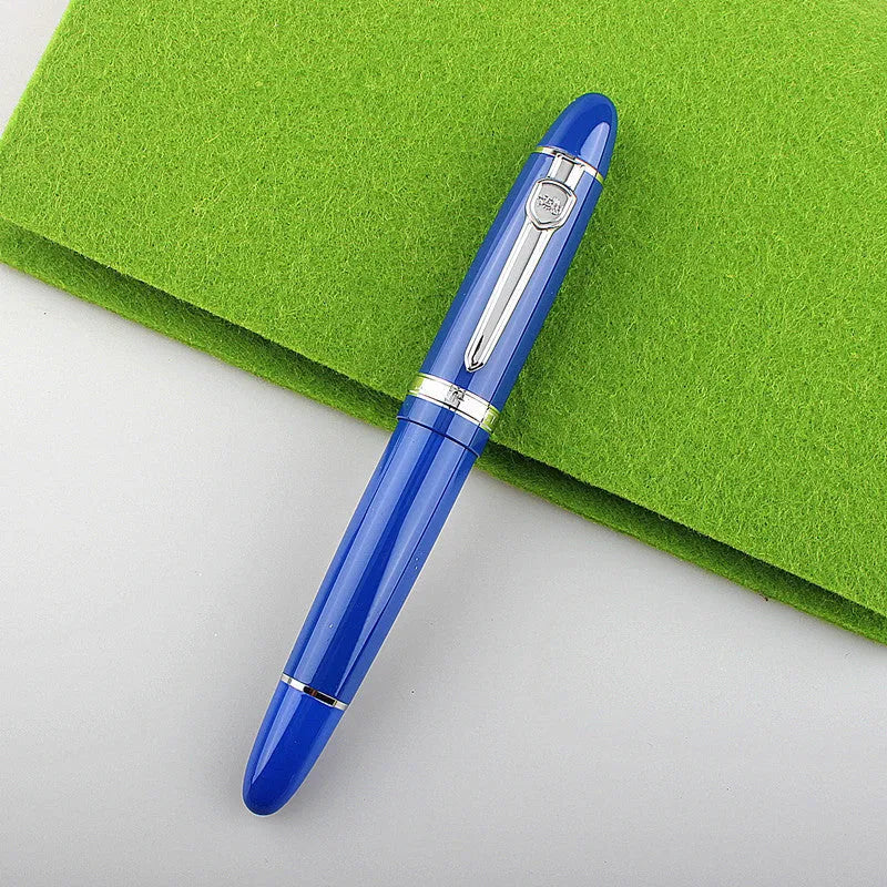 Metal ball pen with pearl beads, black body and silver clip, lying on a desk