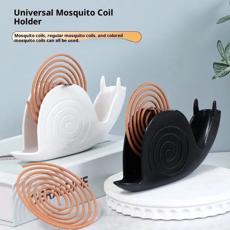 Black plastic universal mosquito incense holder on a table, simple portable design with creative animal style