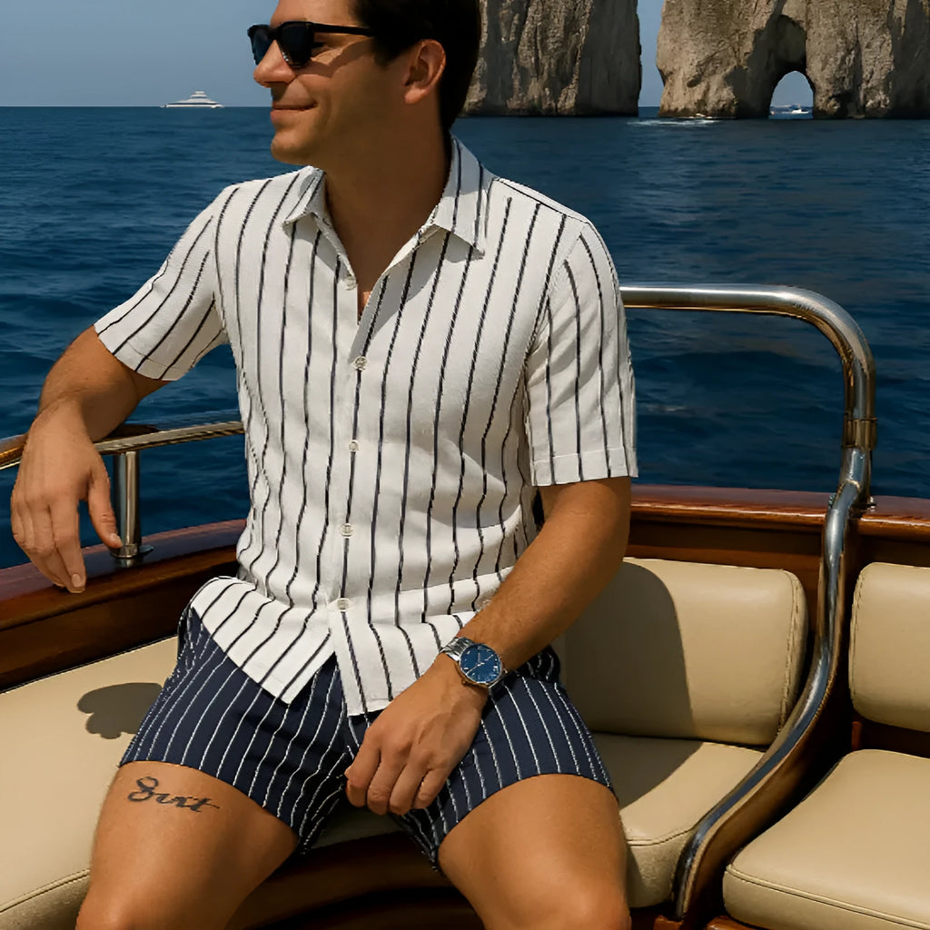 Men's light blue beach shirt and matching shorts set laid flat, showing casual style and elastic fabric texture.