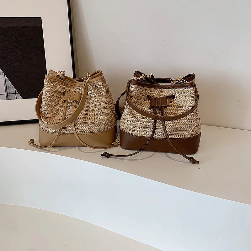 Brown woven straw women's crossbody bucket bag with horizontal square shape and adjustable strap